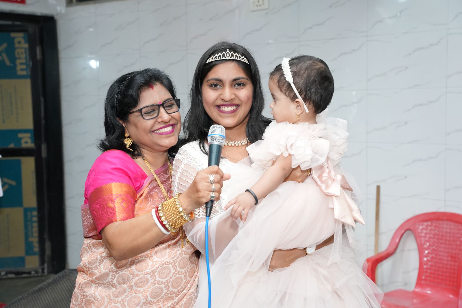 Anchor Ananya Kundu with a family at a milestone celebration