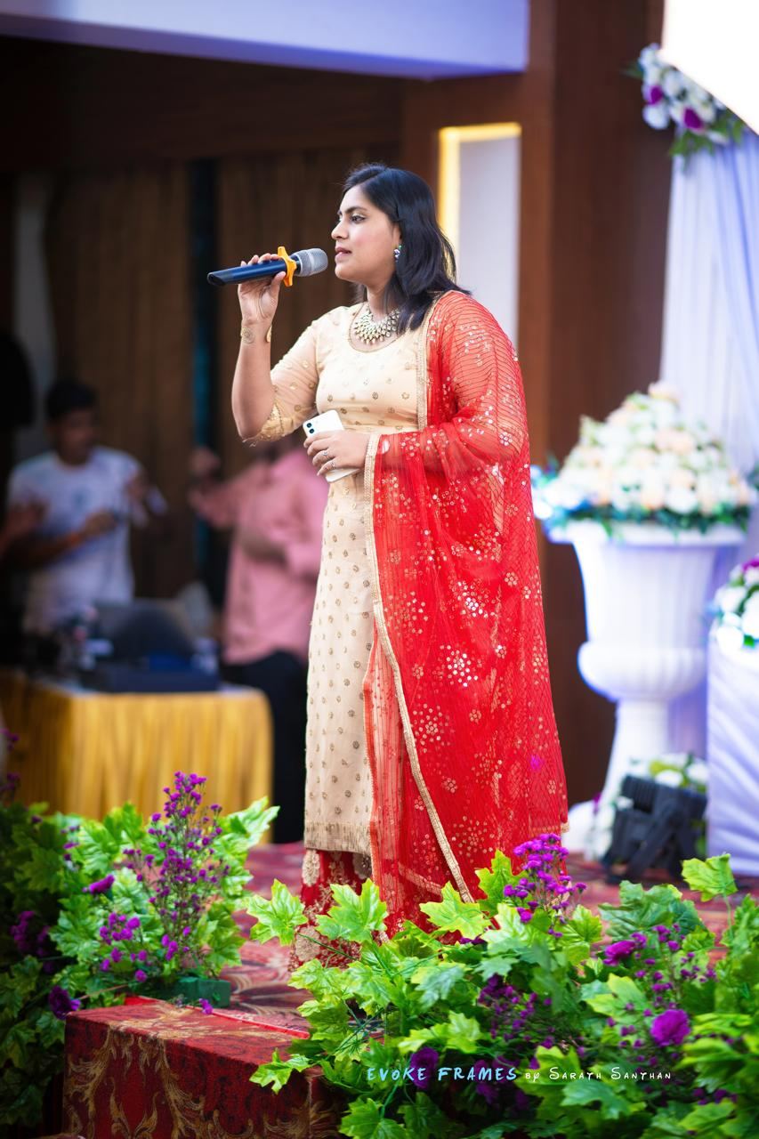 Anchor Ananya Kundu hosting an engagement ceremony on stage