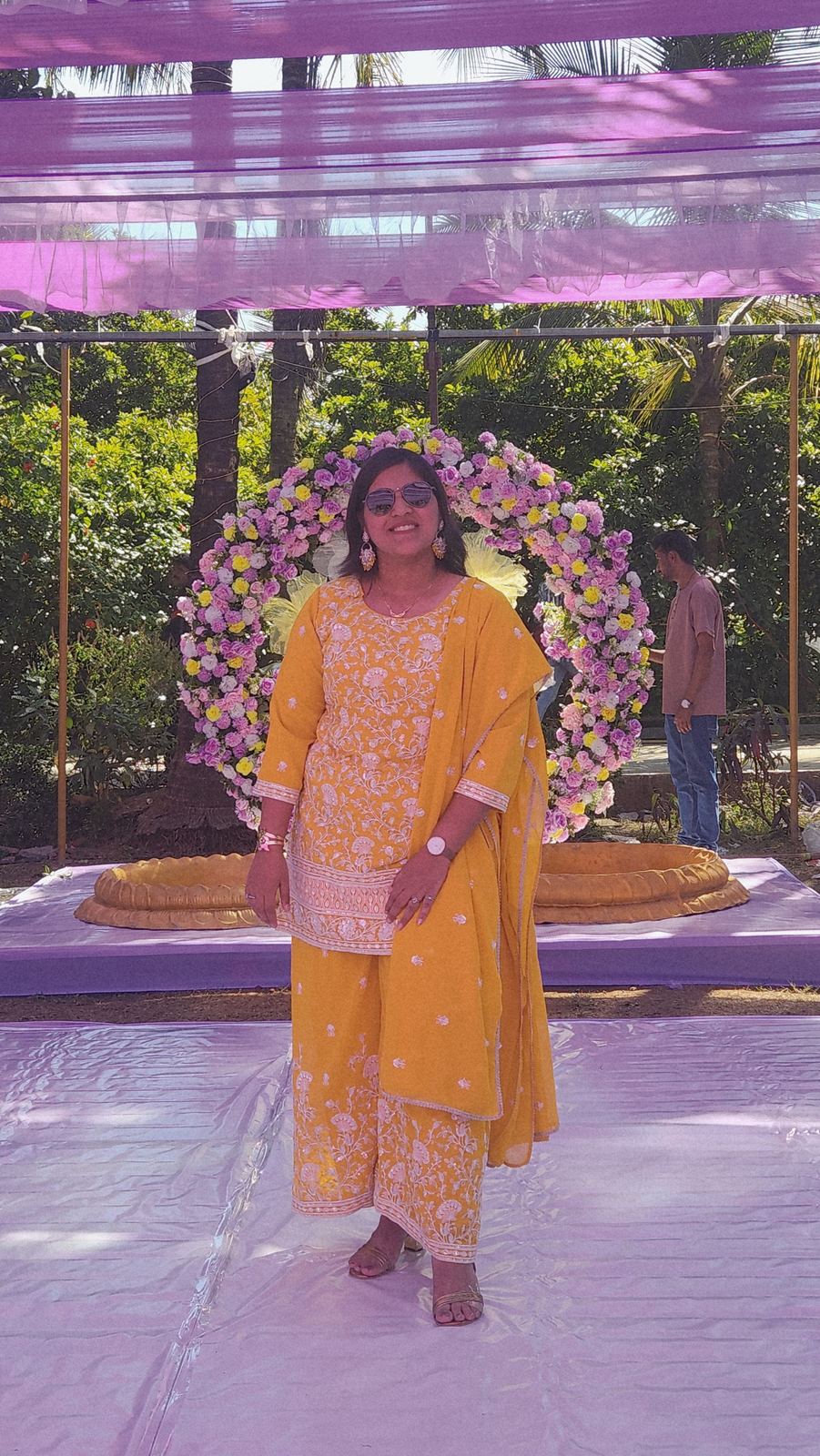 Anchor Ananya Kundu in yellow hosting a haldi ceremony