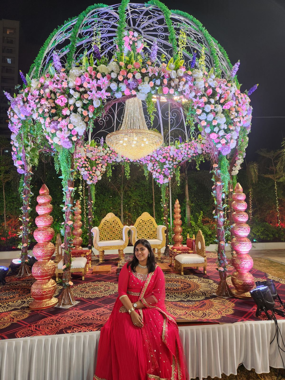 Anchor Ananya Kundu under a lit canopy at a wedding